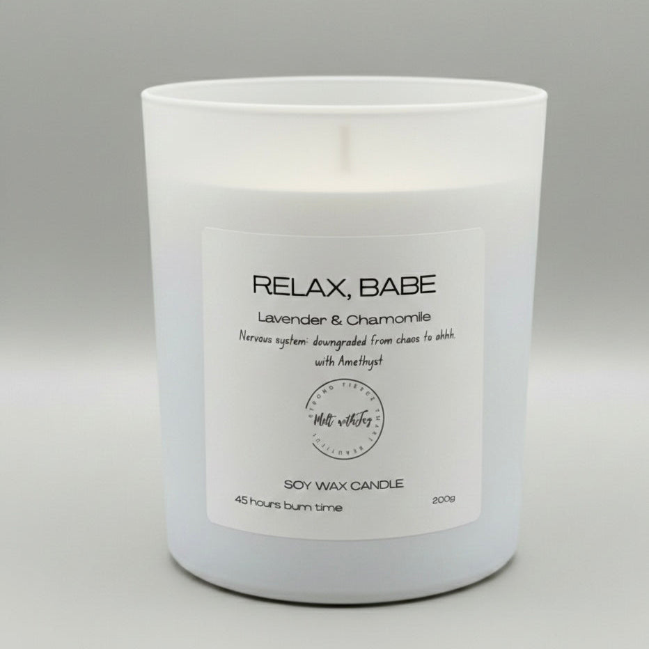 White candle with a label on a gray background