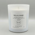 White candle with a label on a gray background