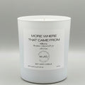 White candle with a label on a gray background