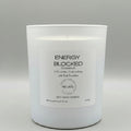 White candle with a label on a gray background