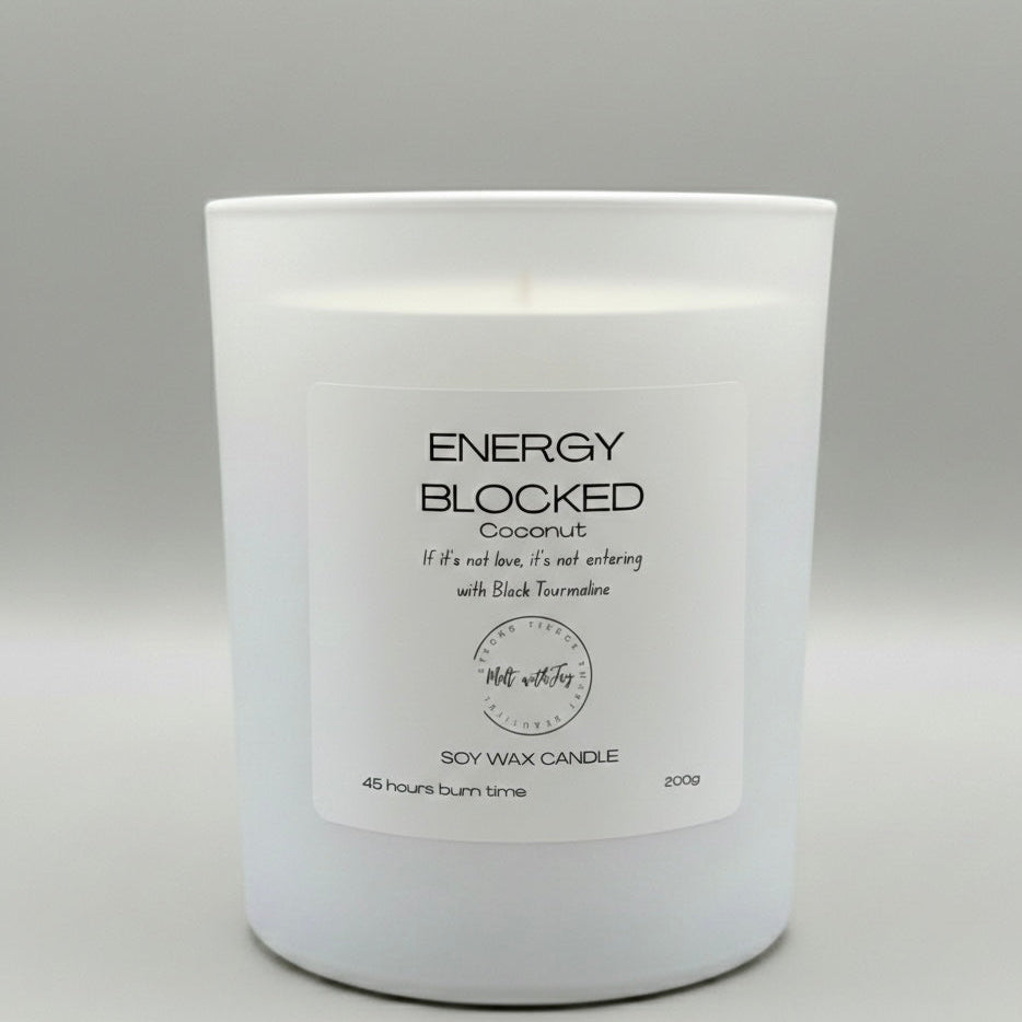 White candle with a label on a gray background