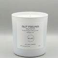 White candle with a label on a gray background
