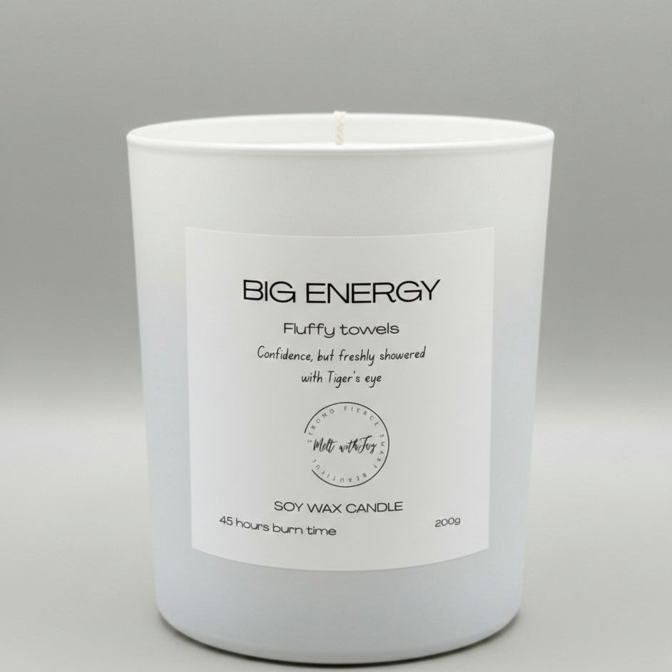 White candle with a label on a gray background