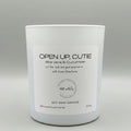 White candle with a label on a gray background