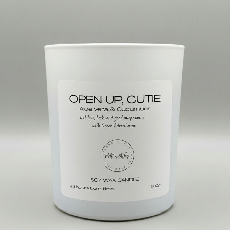 White candle with a label on a gray background